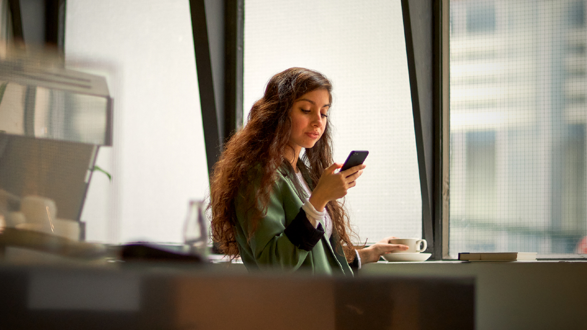 business-woman-checks-her-phone-sparklab.jpg